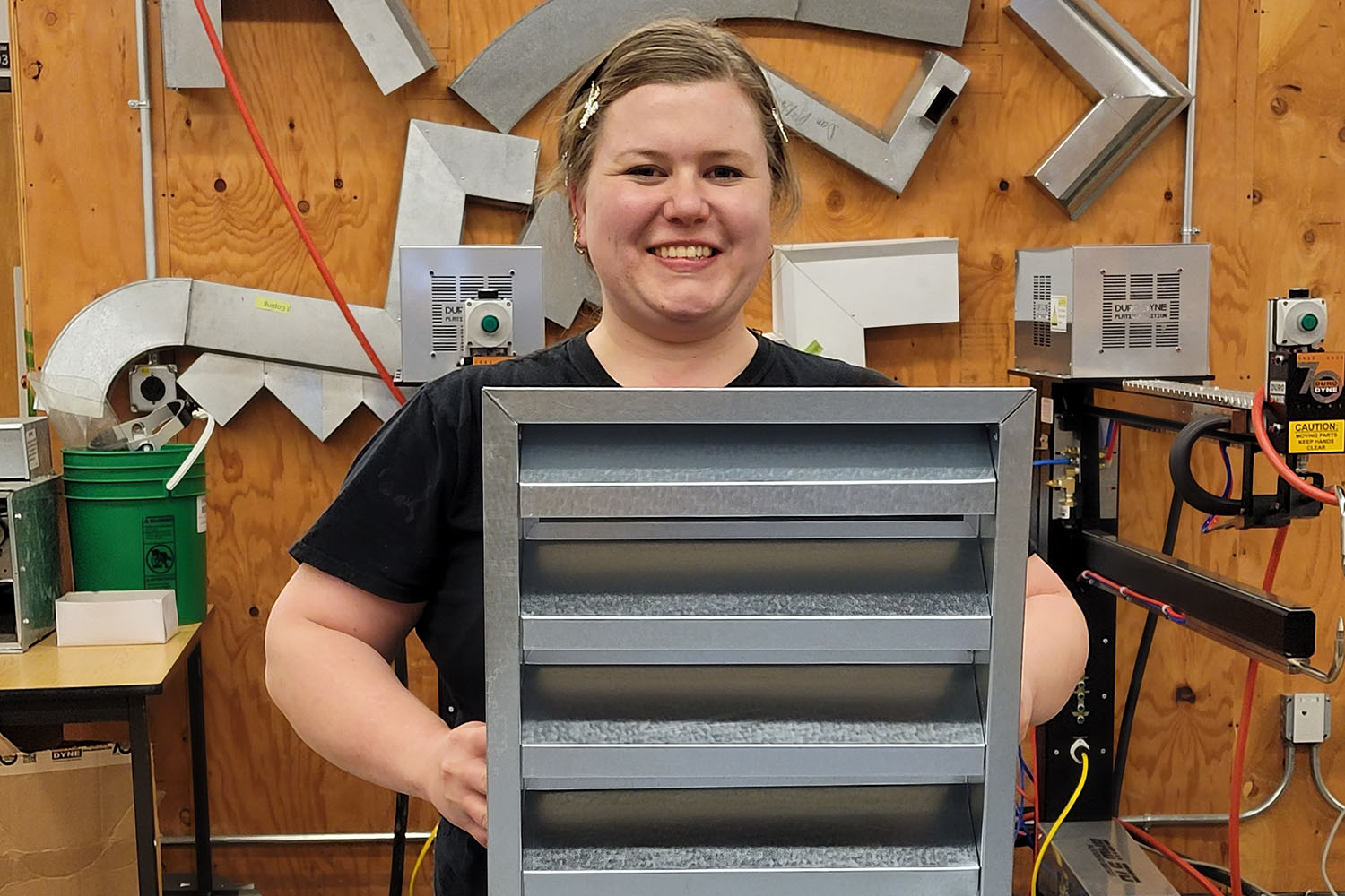 A female third year apprenticeship student in the shop